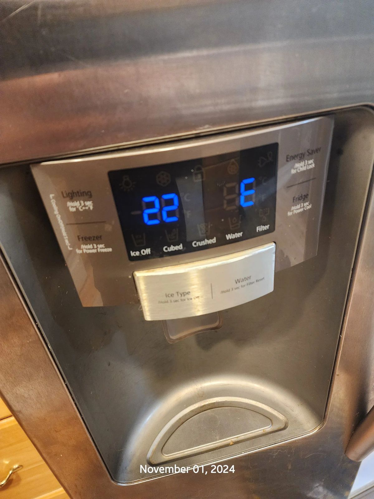 Close-up of a refrigerator's digital control panel showing temperatures and ice settings.